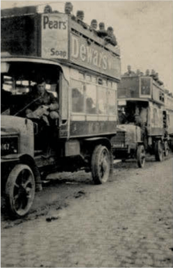 Civilian buses, complete with incongruous advertisements for soap and whisky, pressed into service to transport troops on the Western Front.